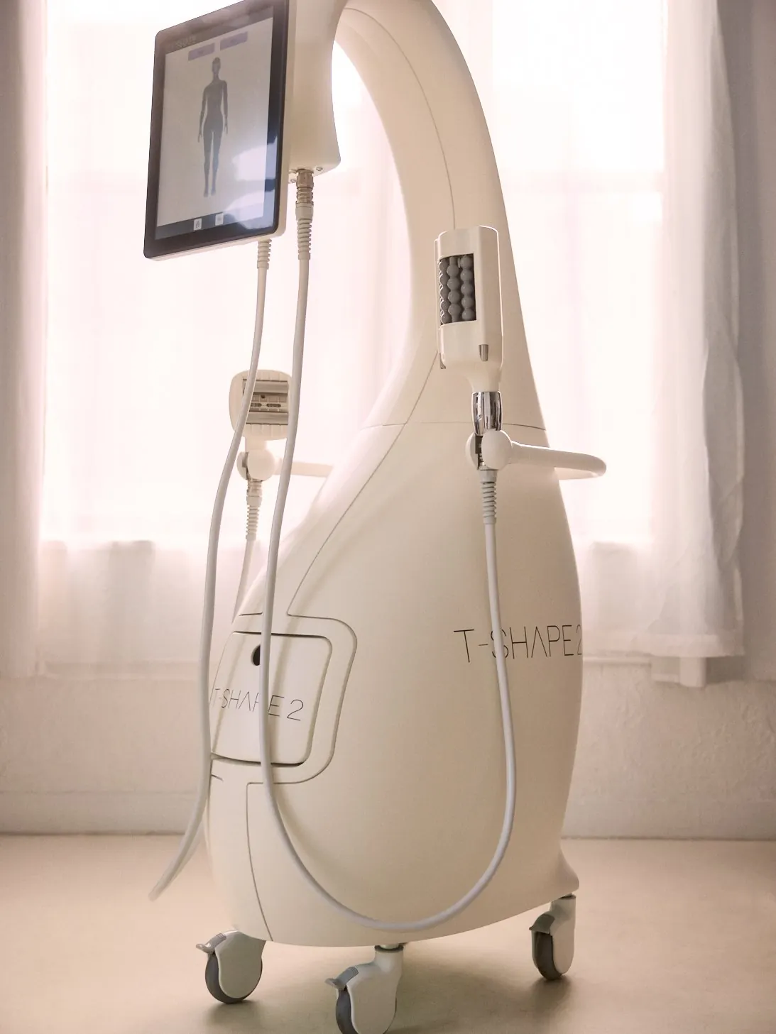The T-Shape 2 device: a white, curved console with a touchscreen and handpieces